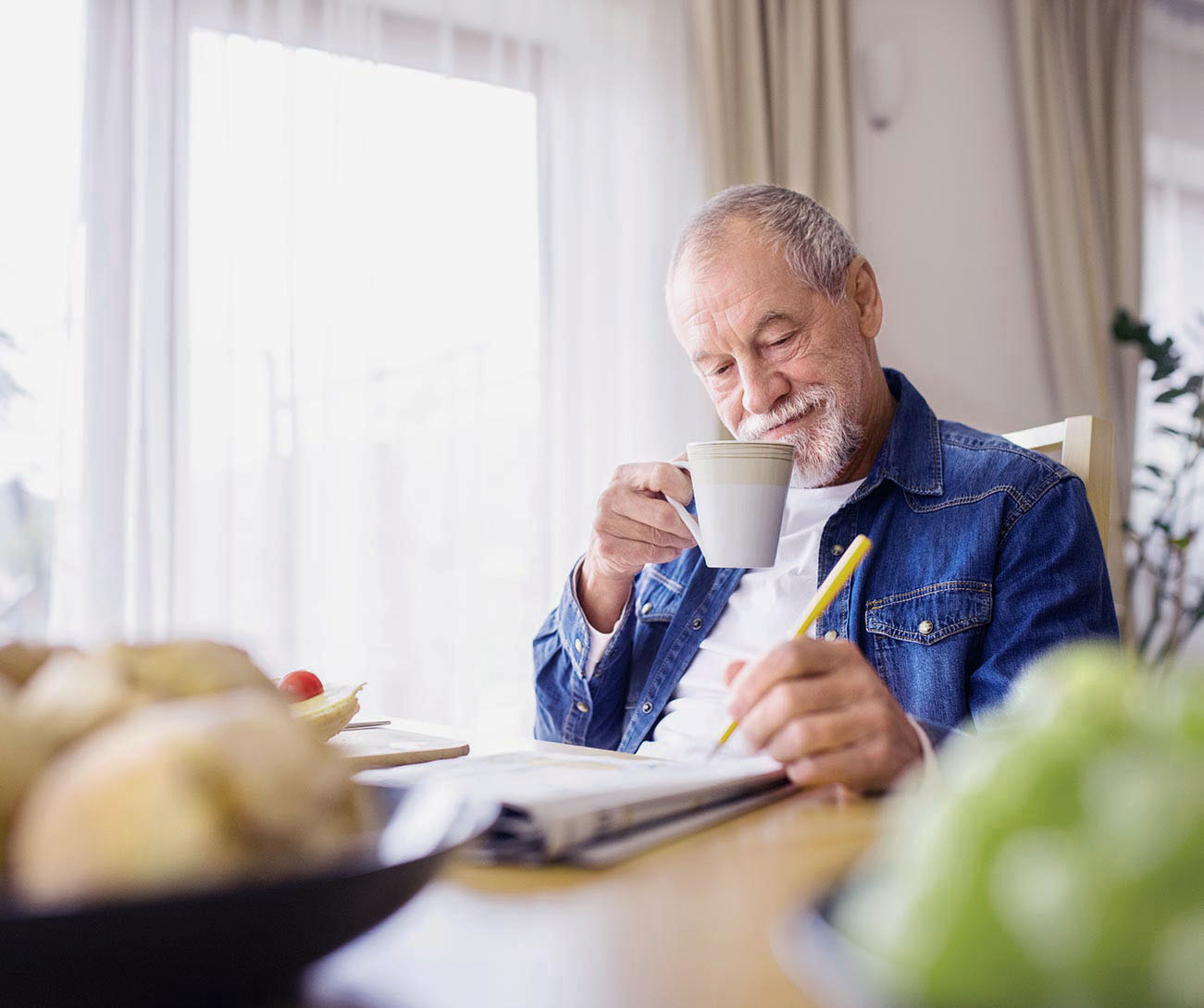 Man with drink, reading the newspaper